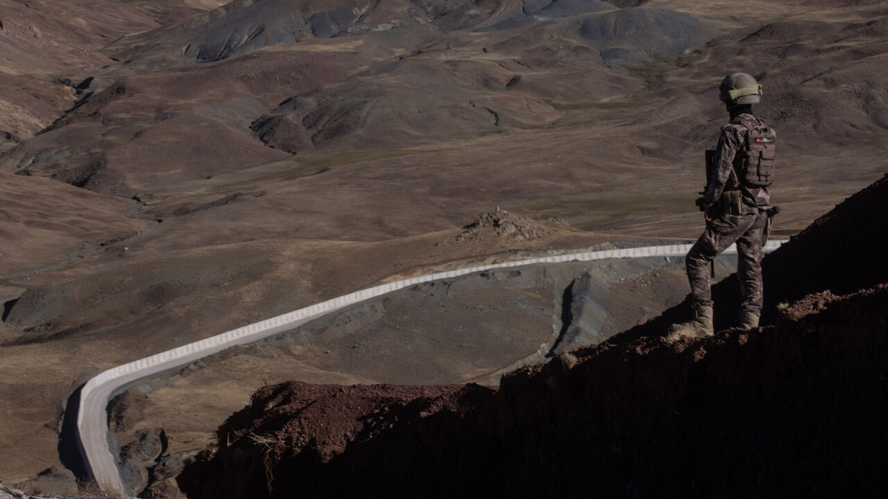 A Turkish Special Forces Police officer is seen standing watch during a press tour at a border outpost in front of a section of the new Iran - Turkey border wall on Sept. 27, 2021 in Caldiran, Turkey. 