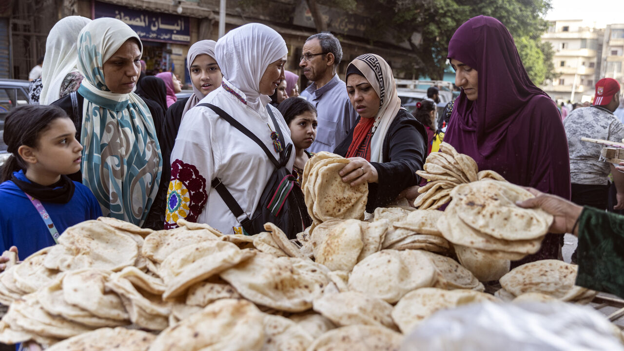 Women buy bread from a local bread stand in Al Fustat neighborhood on May 2, 2022, in Cairo, Egypt. 