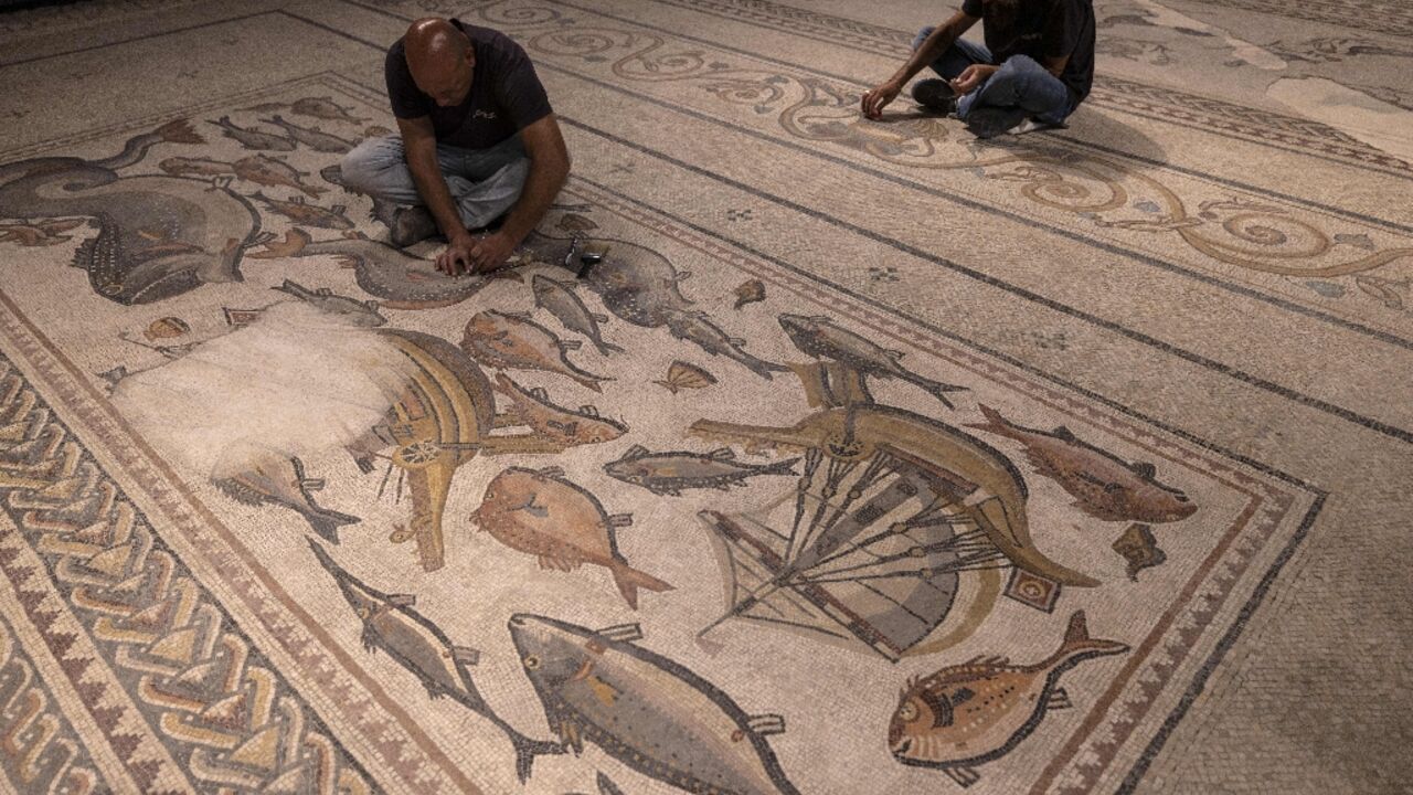Israel Antiquities Authority workers attend to on the 1,700-year-old Lod mosaic Israel Antiquities Authority workers attend to on the 1,700-year-old Lod mosaic
