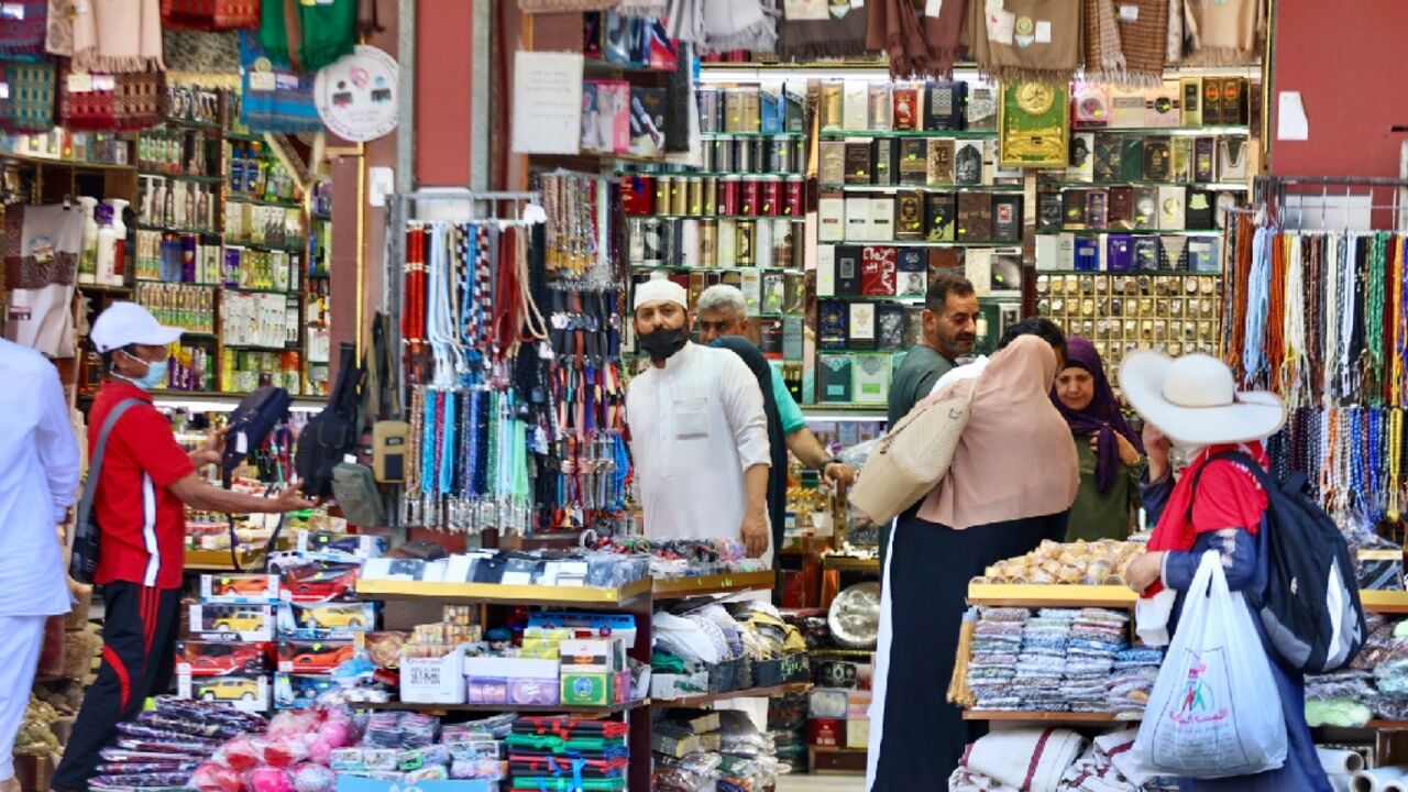 Muslim pilgrims shop at a market in Mecca -- the hajj is welcoming its first international visitors since 2019 Muslim pilgrims shop at a market in Mecca -- the hajj is welcoming its first international visitors since 2019