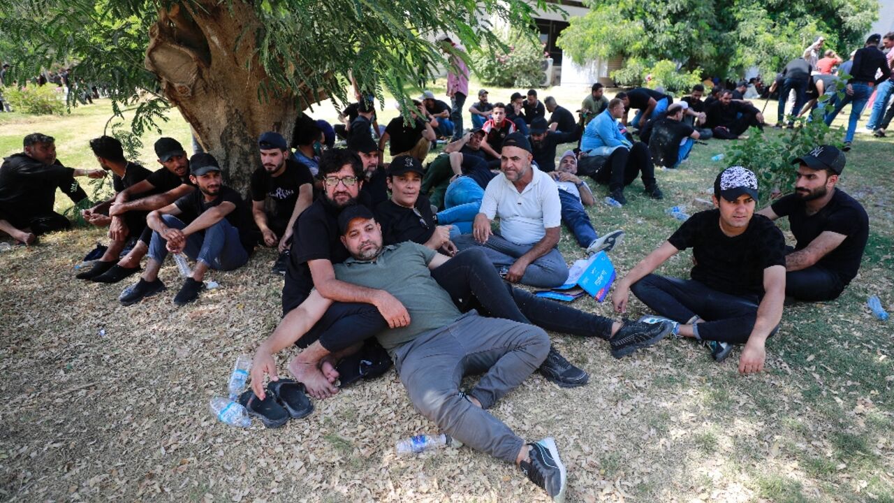 Supporters of Shiite cleric Moqtada Sadr camp out in the gardens of parliament after occupying the building in Baghdad's normally secure Green Zone