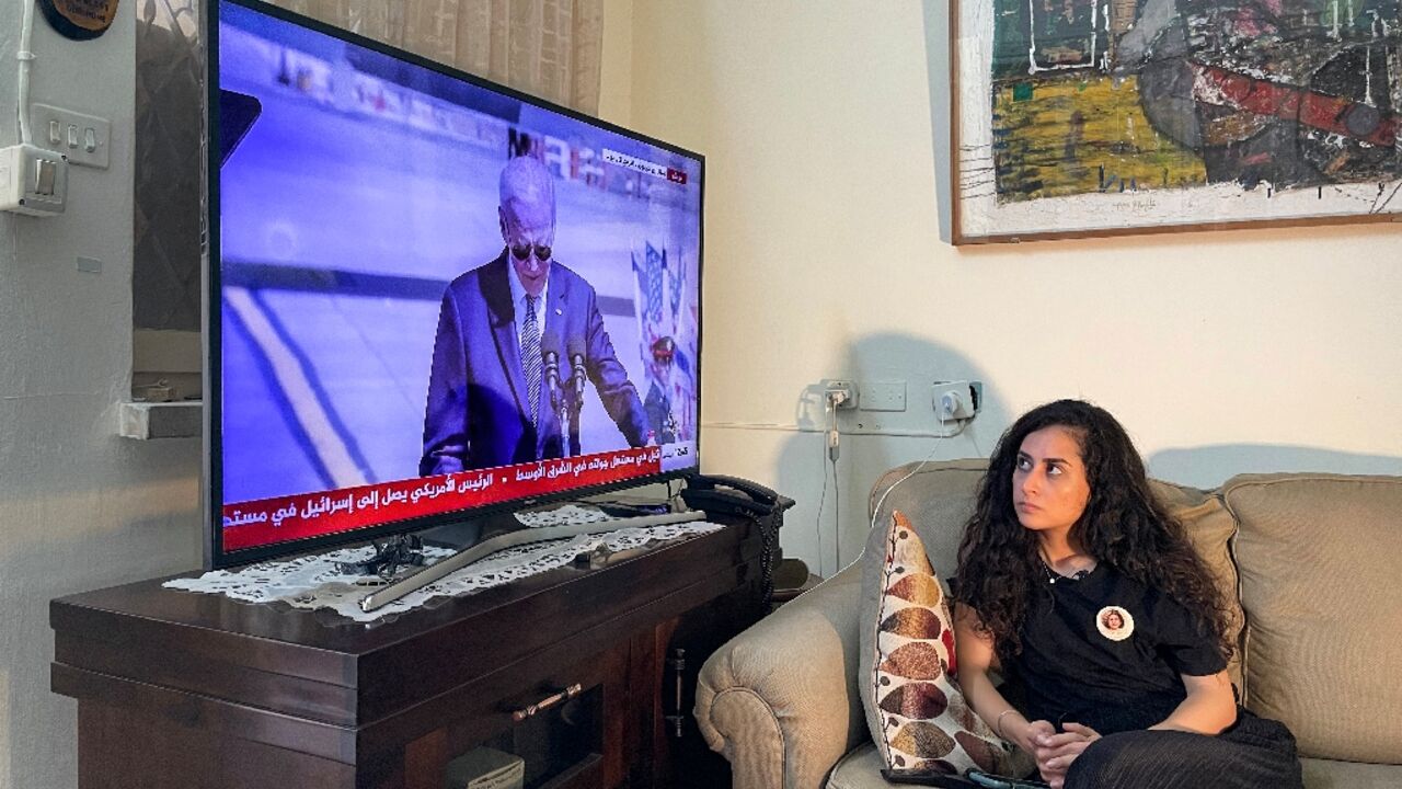 Lina Abu Akleh, the niece of slain Al Jazeera journalist Shireen Abu Akleh, watches at the family home in occupied east Jerusalem as US President Joe Biden speaks upon his arrival at Tel Aviv's Ben Gurion airport