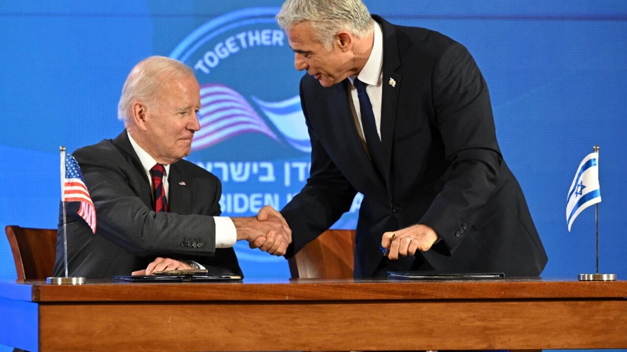 US President Joe Biden and Israel's caretaker Prime Minister Yair Lapid shake hands before signing a security pledge in Jerusalem US President Joe Biden and Israel's caretaker Prime Minister Yair Lapid shake hands before signing a security pledge in Jerusalem