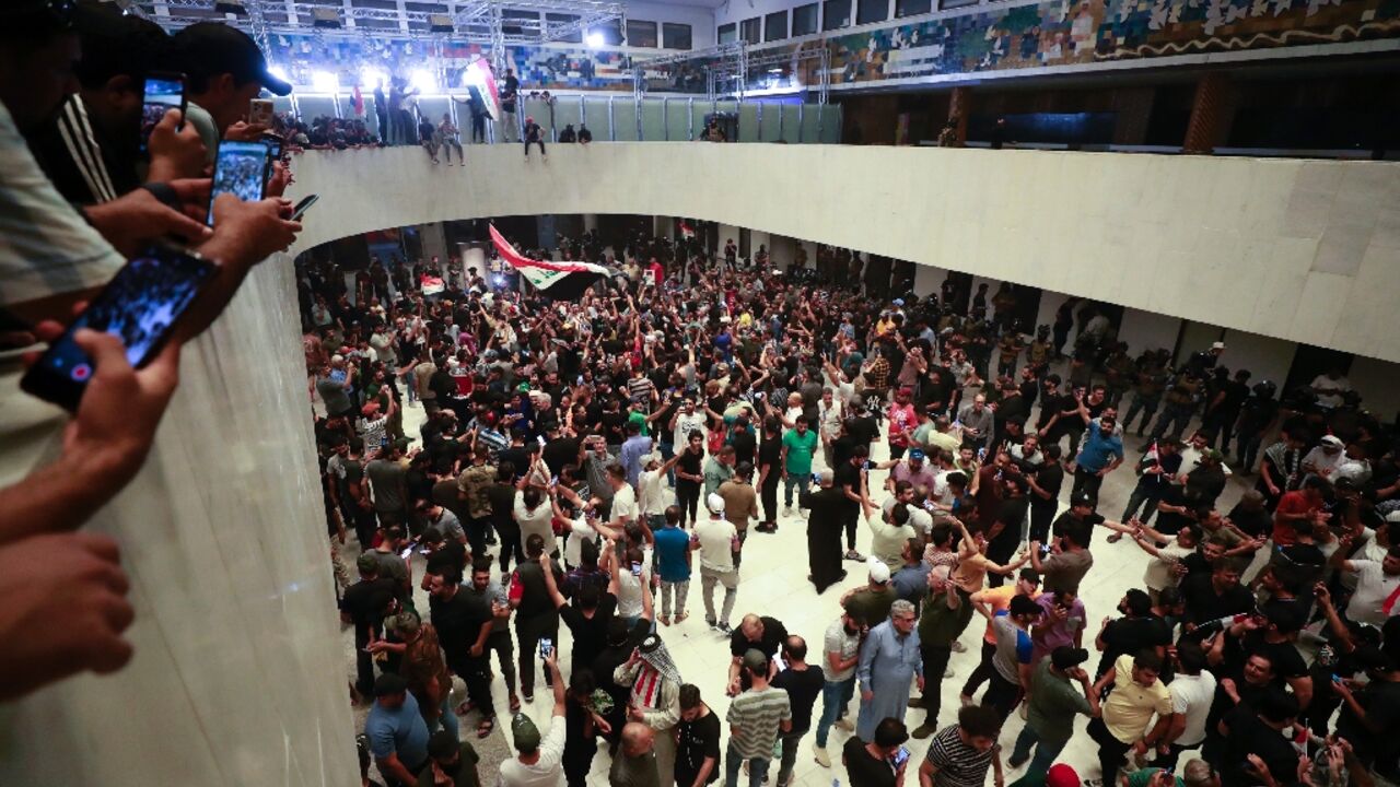 Supporters of Iraqi cleric Moqtada Sadr gather inside  Iraq's parliament in Baghdad's high-security Green Zone on Wednesday night