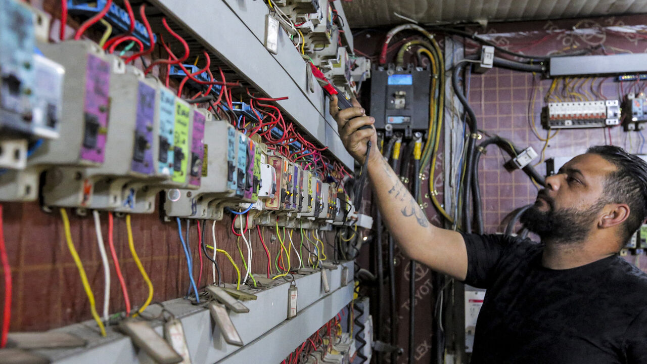 Iraqi Aqeel Hassan, one of the owners of private electric generators, is pictured on July 17, 2021, at his business in Baghdad's Sadr City.