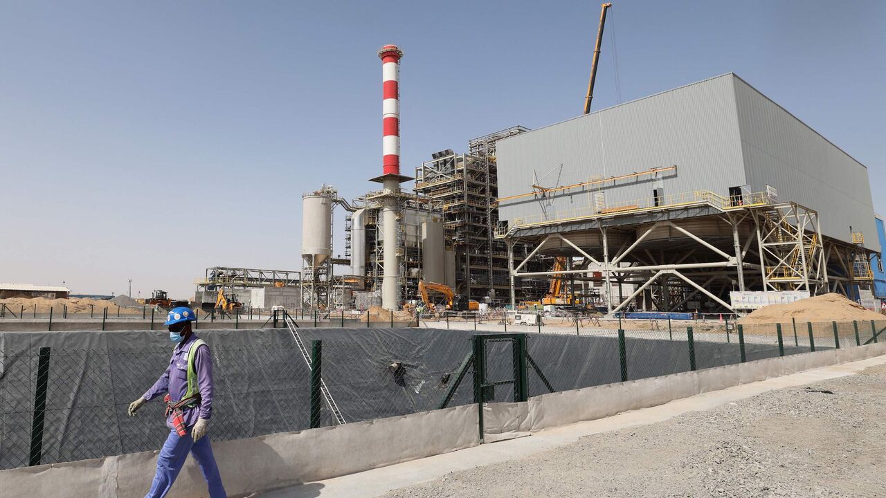 A worker walks past a waste management facility under construction at the Bee'ah company in the Gulf emirate of Sharjah.