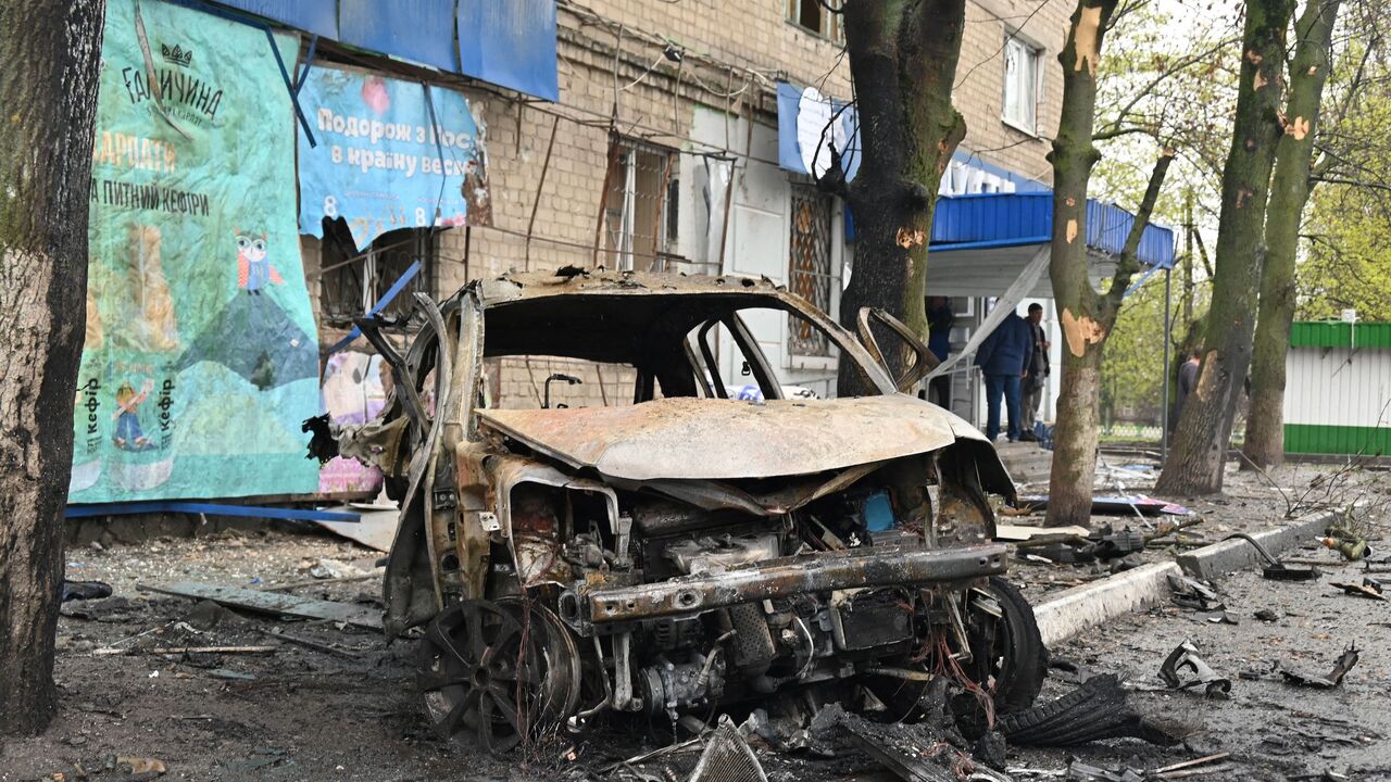 Debris from a destroyed car litter the street at the scene of an explosion near a grocery store, following bombardment at in Ukraine's second city Kharkiv on April 18, 2022.