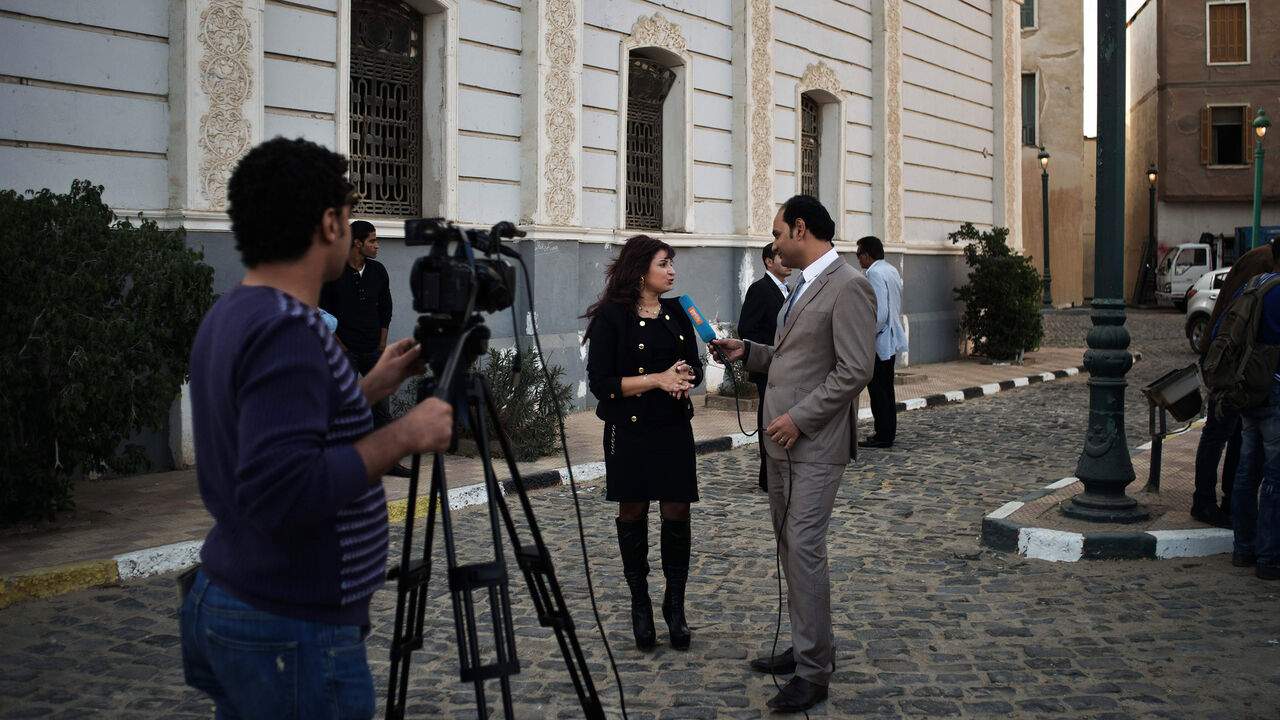 An Egyptian actress gives an interview to a local TV channel before the start of a shooting on the set of "Murafaa" soap opera, Media City, Cairo, Egypt, Nov. 28, 2013.