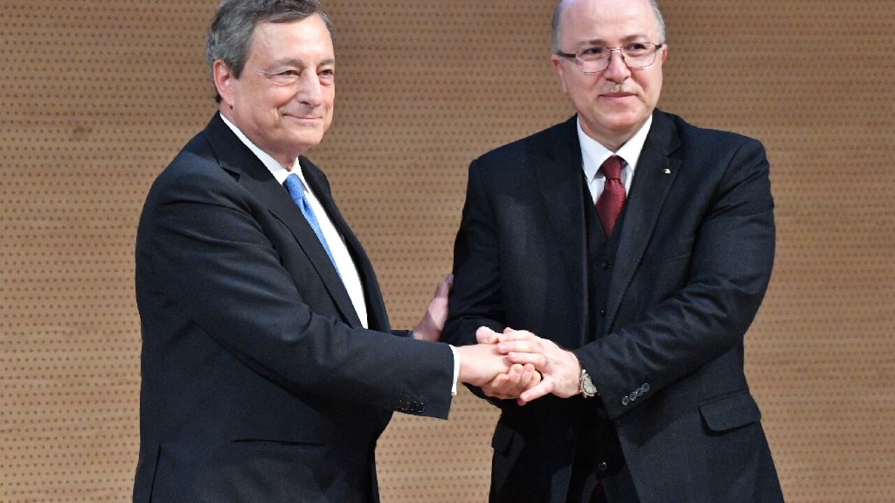 Italian Prime Minister Mario Draghi (L) and Algeria's Prime Minister Aimene Benabderrahmane shake hands in Algiers. Algeria is Africa's biggest gas exporter and supplies around 11 percent of the natural gas consumed in Europe