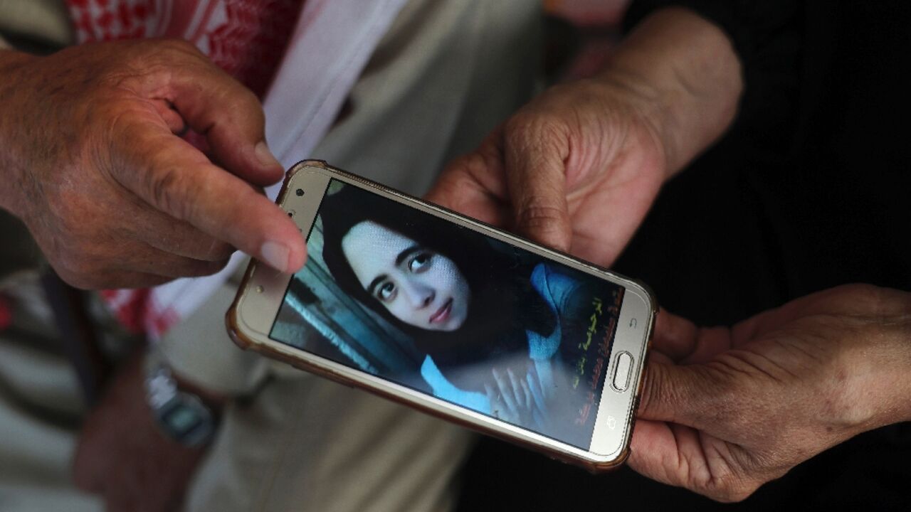 Palestinians Suleiman and Nazmiya Baraka display a picture of their daughter Istabraq, who was killed by her husband last year in the Gaza Strip Palestinians Suleiman and Nazmiya Baraka display a picture of their daughter Istabraq, who was killed by her husband last year in the Gaza Strip