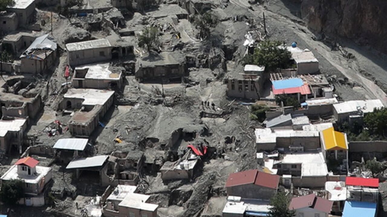 Houses surrounded by mud deposits at the site of a flash flood east of Tehran in the Firouzkouh area, where a landslide killed 14 people