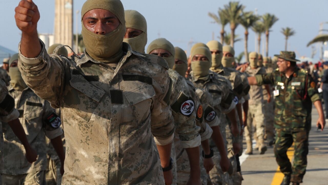 Masked Libyan soldiers take part in a military parade in the capital Tripoli on August 9 Masked Libyan soldiers take part in a military parade in the capital Tripoli on August 9