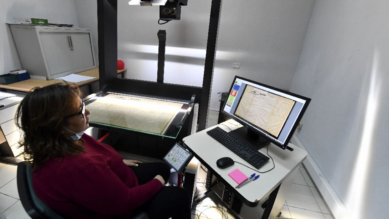 An employee at the National Library of Tunisia consults scanned documents An employee at the National Library of Tunisia consults scanned documents