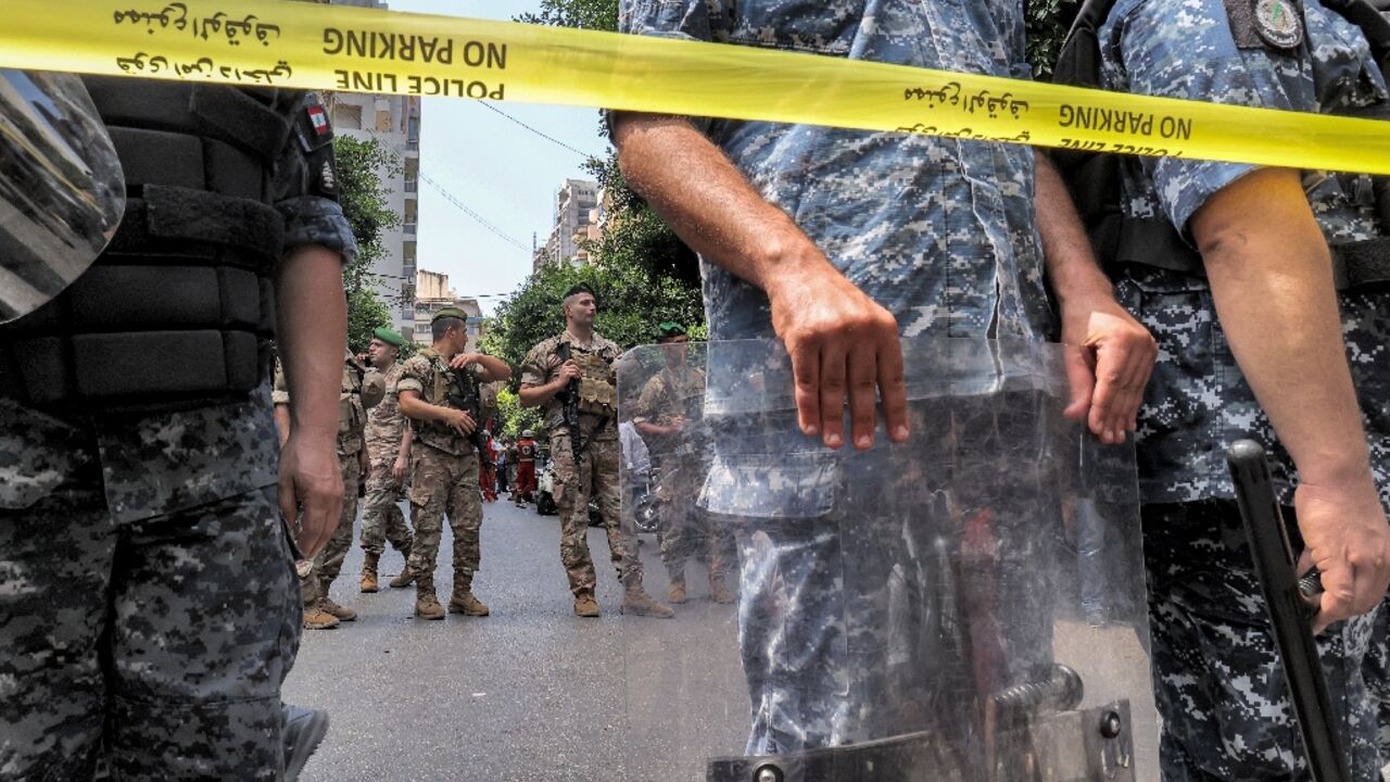 Lebanese security forces stand guard outside a Federal Bank branch in west Beirut