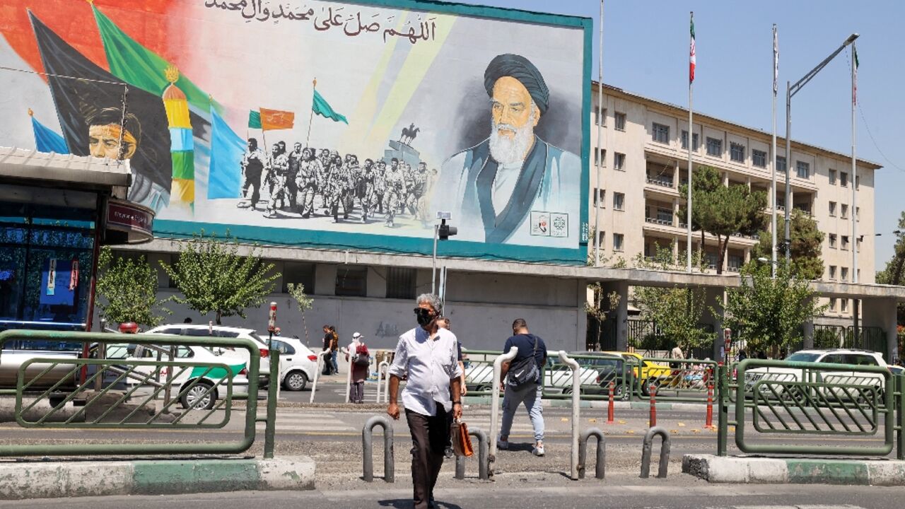 Iranians in Tehran walk past a billboard bearing a portrait of the late supreme leader Ayatollah Ruhollah Khomeini, who in 1989 issued a fatwa calling for author Salman Rushdie to be killed Iranians in Tehran walk past a billboard bearing a portrait of the late supreme leader Ayatollah Ruhollah Khomeini, who in 1989 issued a fatwa calling for author Salman Rushdie to be killed