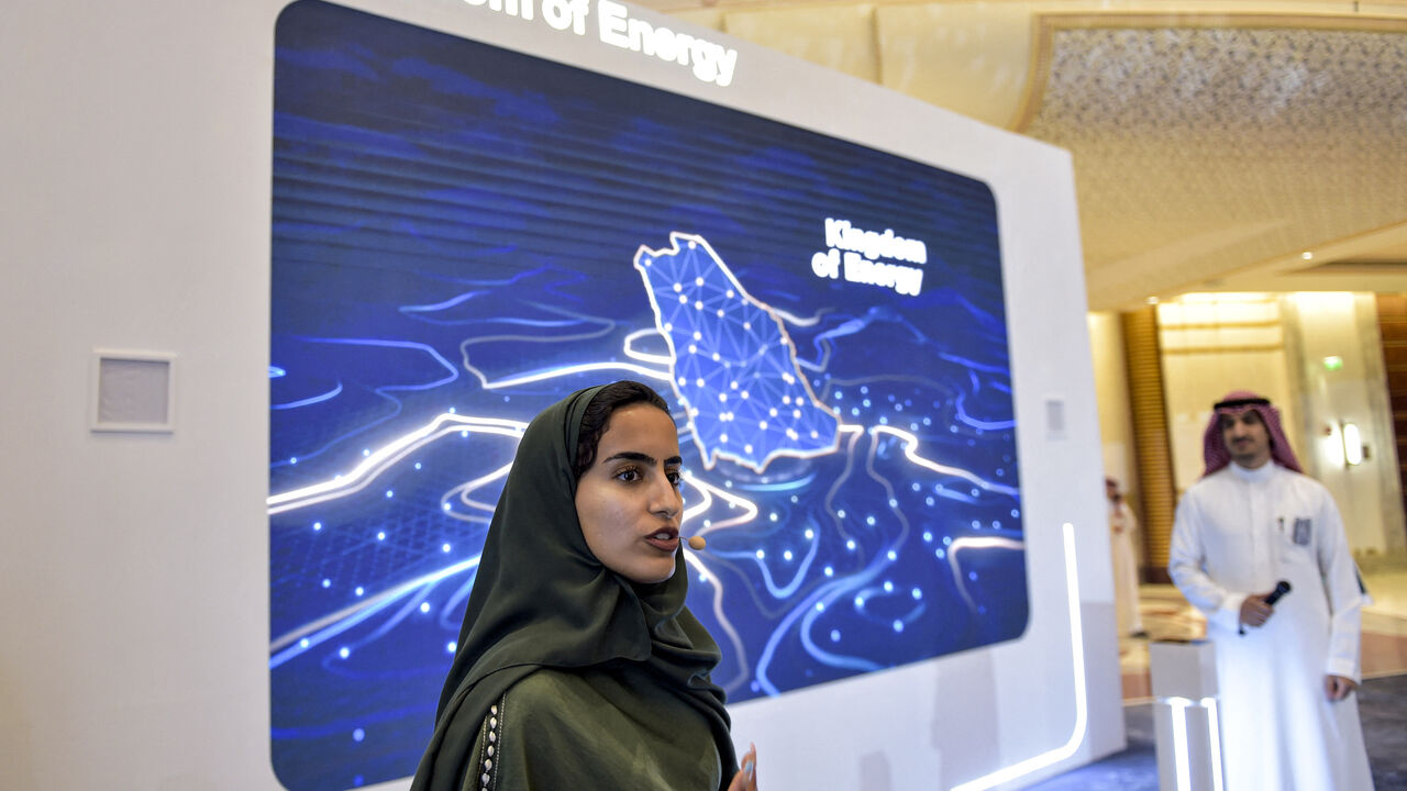 A picture taken in the Saudi Red Sea coastal city of Jeddah on July 14, 2022 shows a Saudi host addressing guests