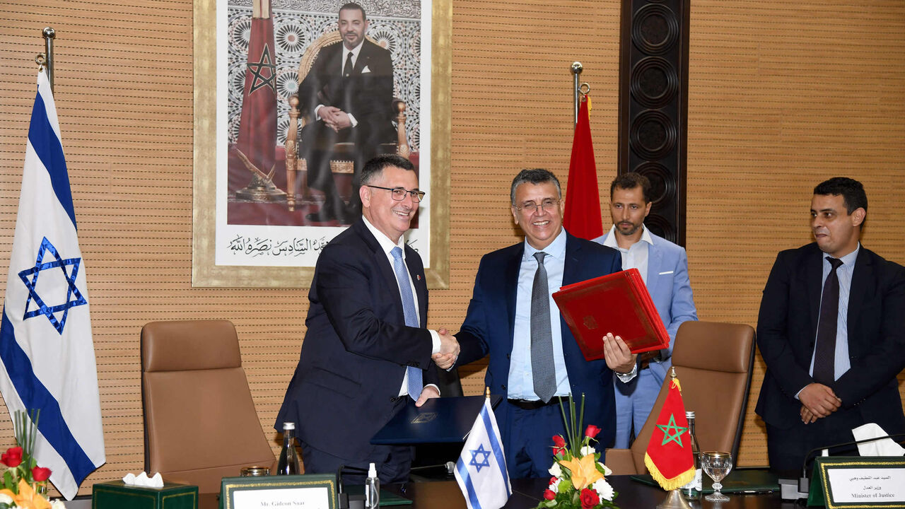 Moroccan Justice Minister Abdellatif Wehbe (R) and Israeli Justice Minister Gideon Saar (L) shake hands after signing an agreement, Rabat, Morocco, July 26 , 2022.