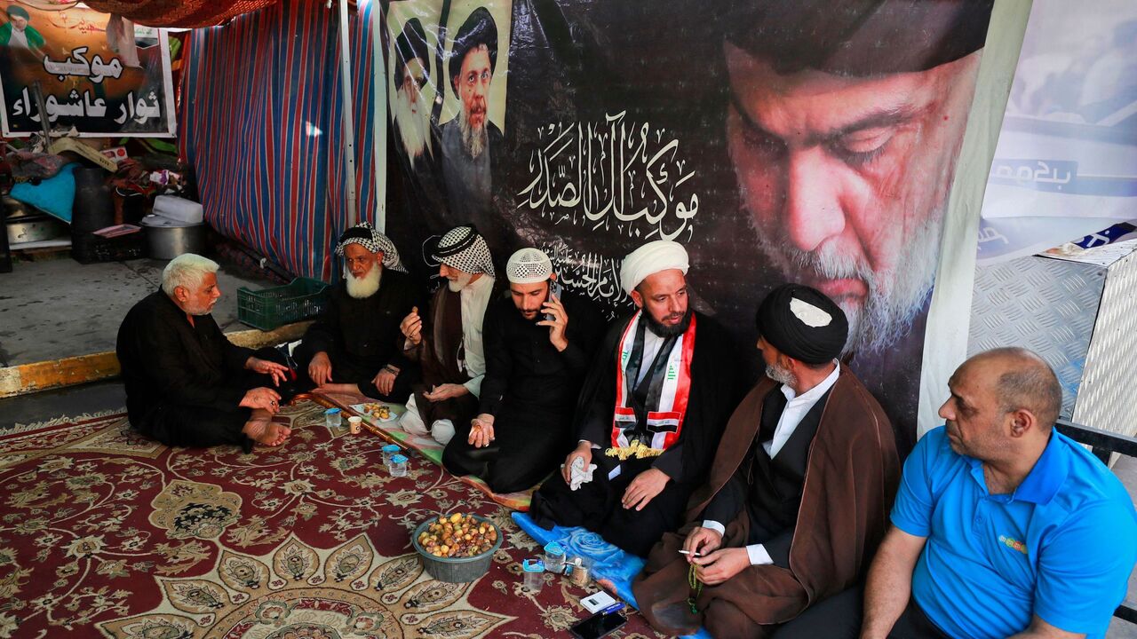 Supporters of Iraqi Shiite cleric Muqtada al-Sadr rest during a protest.