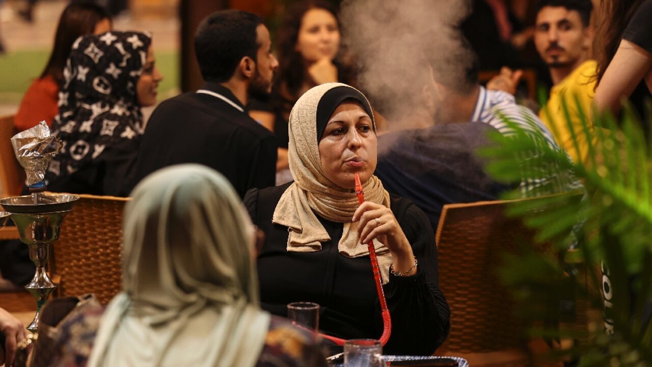 Palestinian women sit at a beach coffee shop in Gaza: but with unemployment rates hitting 47 percent last year, such outings are an unaffordable luxury for many