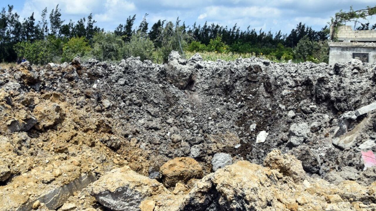 A handout picture released by Syria's official SANA news agency on July 2, 2022, shows a crater caused by a reported Israeli air strike in the western Syrian coastal city of Tartus