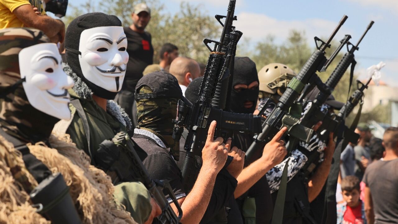 Masked gunmen attend the funeral of Palestinian teenager Uday Salah, killed in clashes with Israeli troops in the occupied West Bank Masked gunmen attend the funeral of Palestinian teenager Uday Salah, killed in clashes with Israeli troops in the occupied West Bank