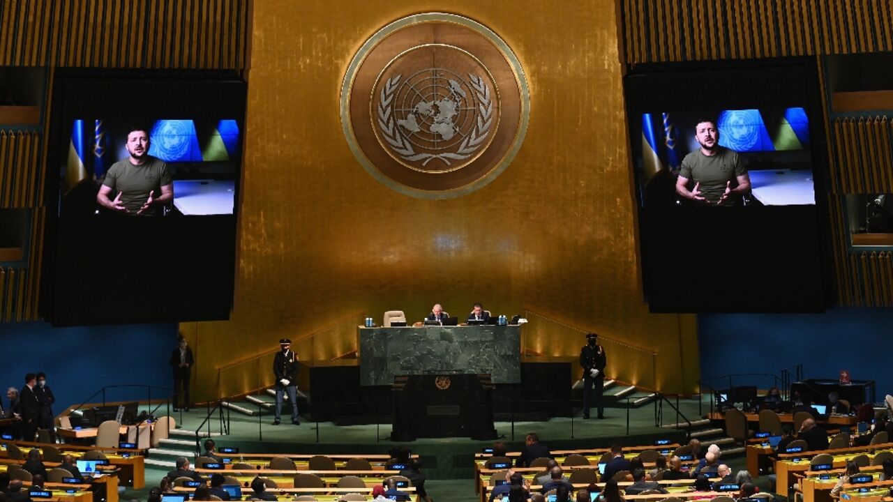 Ukrainian President Volodymyr Zelensky is seen on screen as he remotely addresses the 77th session of the United Nations General Assembly