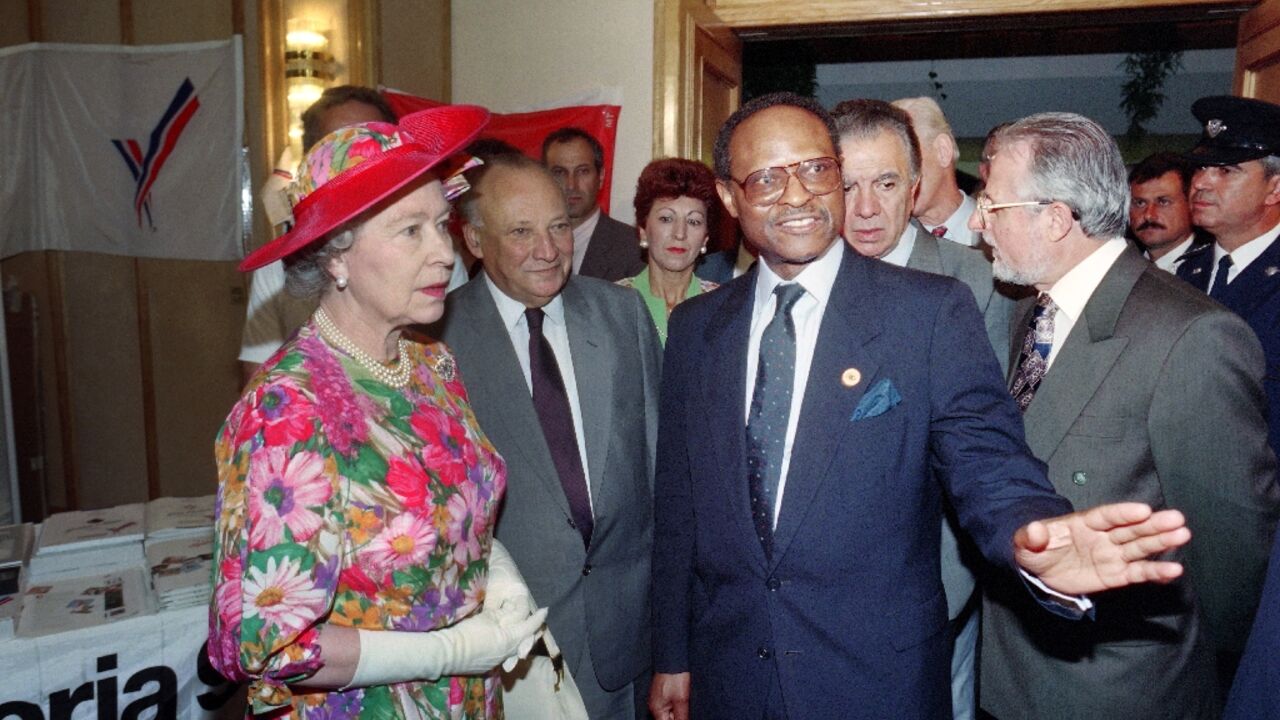 Queen Elizabeth II listens to Commonwealth chief Emeka Anyaoku of Nigeria (R) as Cypriot President Glafcos Clerides (C) looks on during the Queen's visit to the press centre in Limassol on October 20, 1993 Queen Elizabeth II listens to Commonwealth chief Emeka Anyaoku of Nigeria (R) as Cypriot President Glafcos Clerides (C) looks on during the Queen's visit to the press centre in Limassol on October 20, 1993