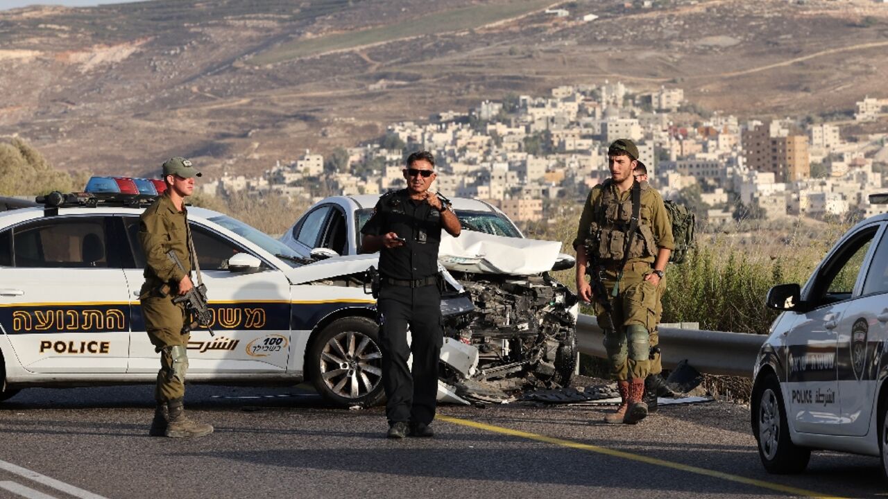 Israeli troops are pictured at the scene in the occupied West Bank where a Palestinian driver was shot dead after what the army called an "attempted ramming attack" but Palestinians said was a traffic accident Israeli troops are pictured at the scene in the occupied West Bank where a Palestinian driver was shot dead after what the army called an "attempted ramming attack" but Palestinians said was a traffic accident