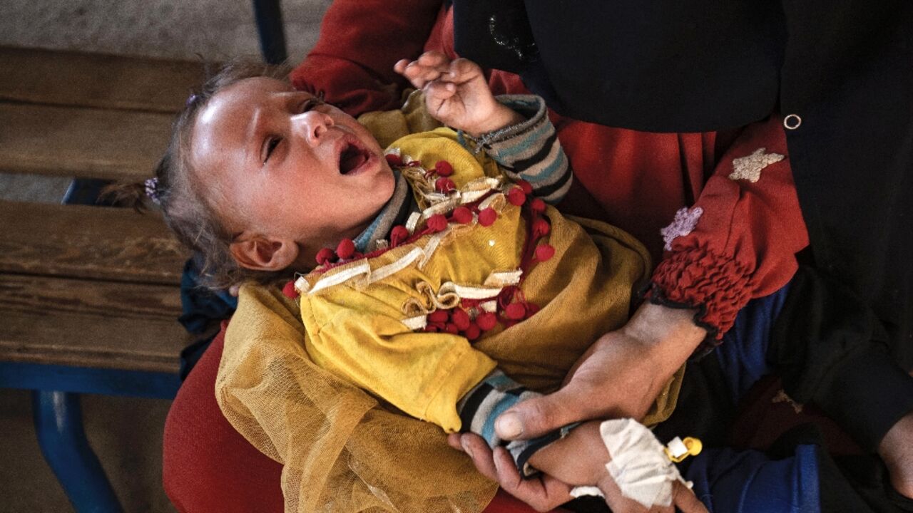 A child suffering from cholera receives treatment at the Al-Kasrah hospital in Syria's eastern province of Deir Ezzor