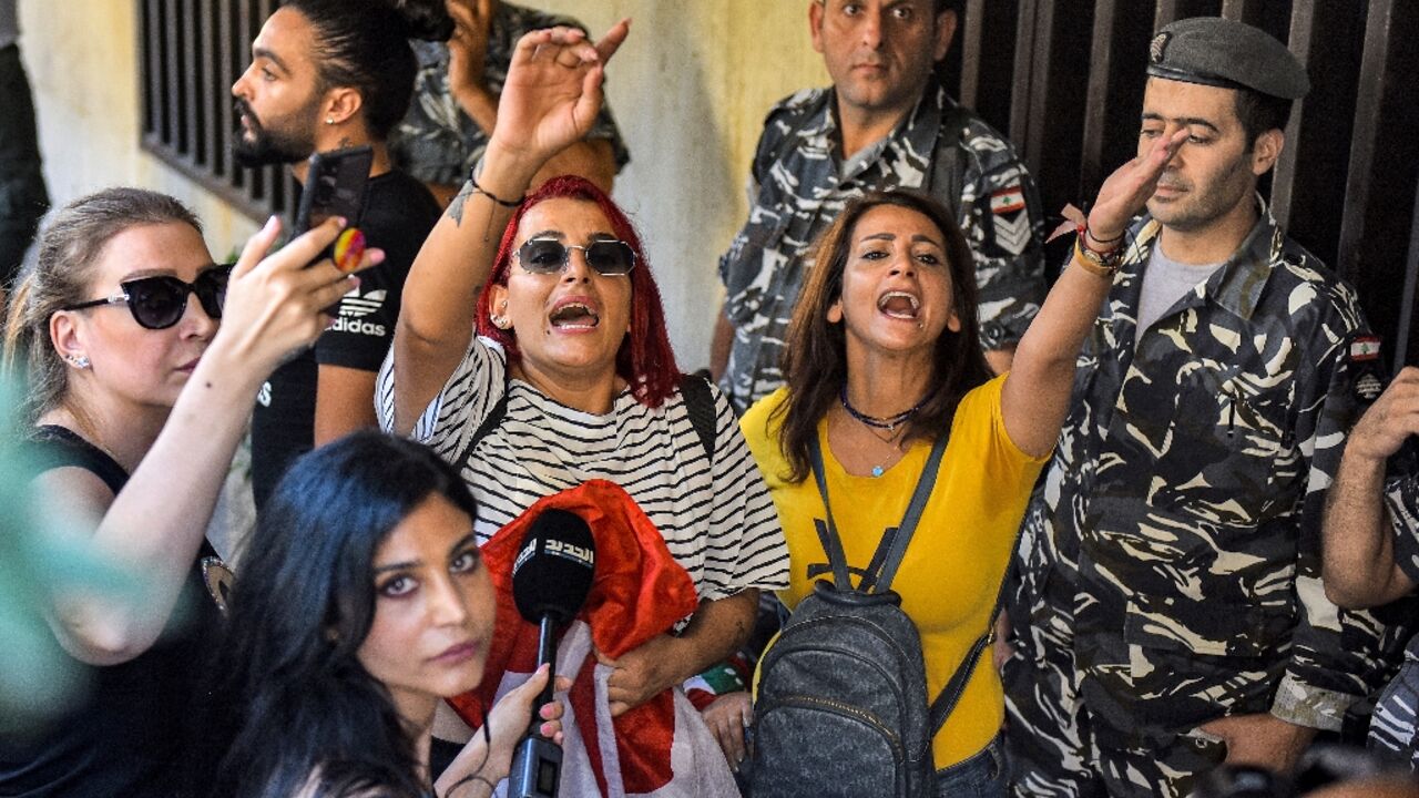 Security forces stand guard amid protests outside a branch of LGB Bank, reportedly held up by a depositor, in the Ramlet al-Bayda area in the capital Beirut on Friday