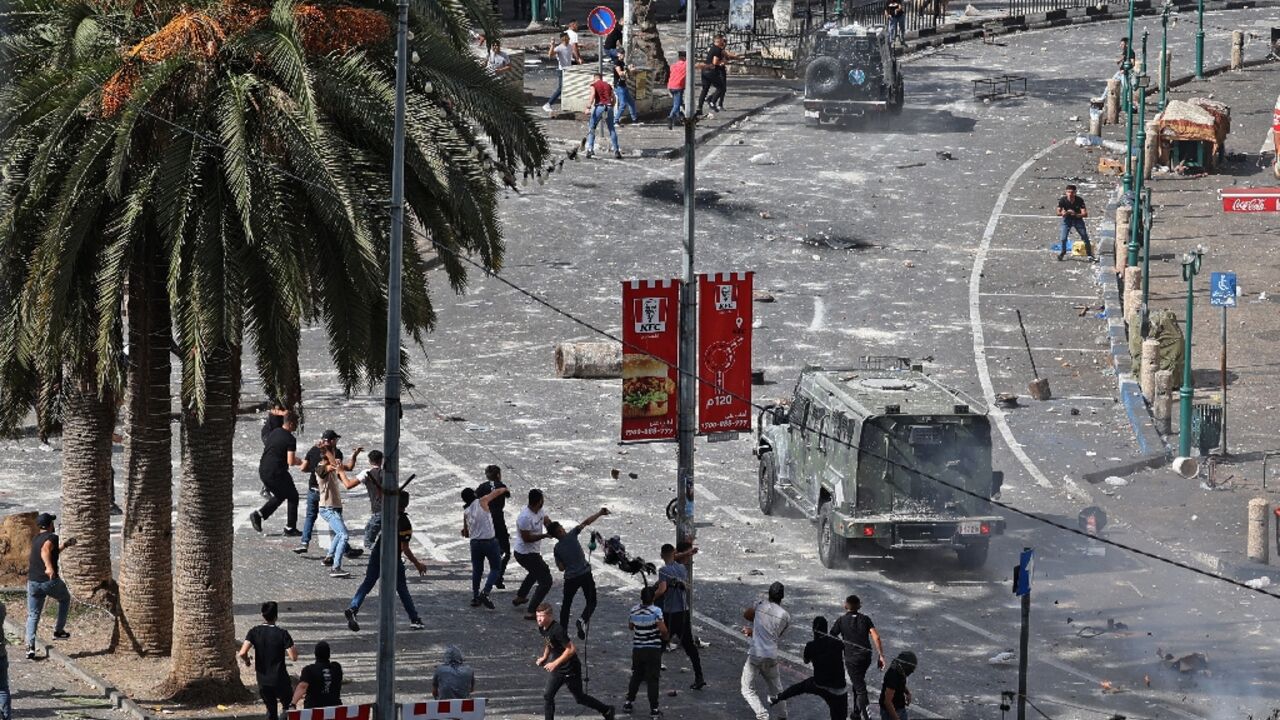Young Palestinians engage in running battles with police in Nablus on Tuesday turning the heart of the West Bank city into a combat zone Young Palestinians engage in running battles with police in Nablus on Tuesday turning the heart of the West Bank city into a combat zone