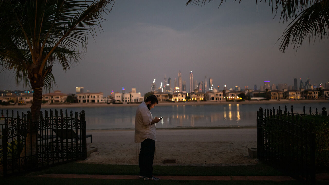 Rabbi Eli, from CTeen International, an orthodox Jewish teen network, checks his phone during the first Sukkot Hop ever to be held in Dubai, United Arab Emirates, Sept. 23, 2021.