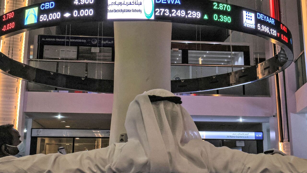 A man watches stock movements on a display at the Dubai Financial Market stock exchange in the Gulf emirate on April 12, 2022. - Shares in the Dubai Electricity and Water Authority (DEWA) rose 16 percent on April 12 in the Gulf region's biggest initial public offering since Saudi oil giant Aramco in 2019. (Photo by Giuseppe CACACE / AFP) (Photo by GIUSEPPE CACACE/AFP via Getty Images)