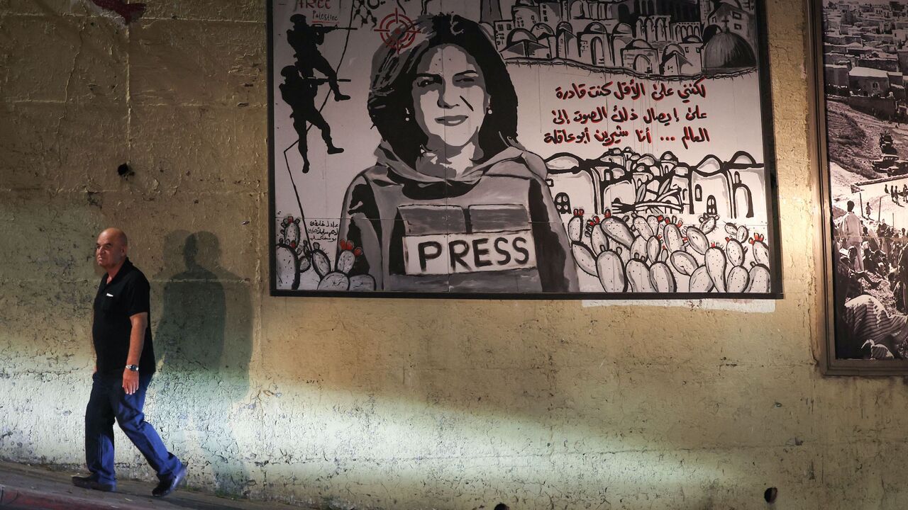 A man walks past a mural depicting slain Palestinian-American journalist Shireen Abu Akleh, on a street in the Arab town of Umm Al-Fahm in northern Israel, on Sept. 5, 2022.