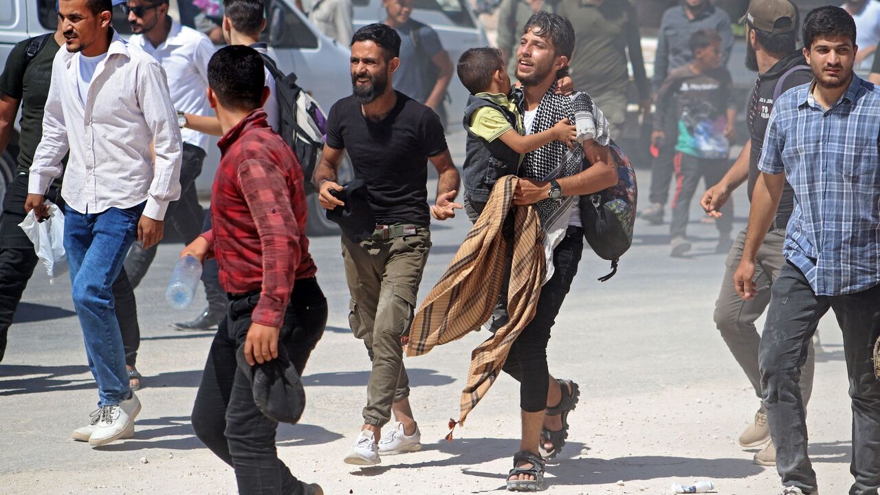 Syrians gather in front of the Bab al-Hawa border crossing with Turkey on Sept. 12, 2022.