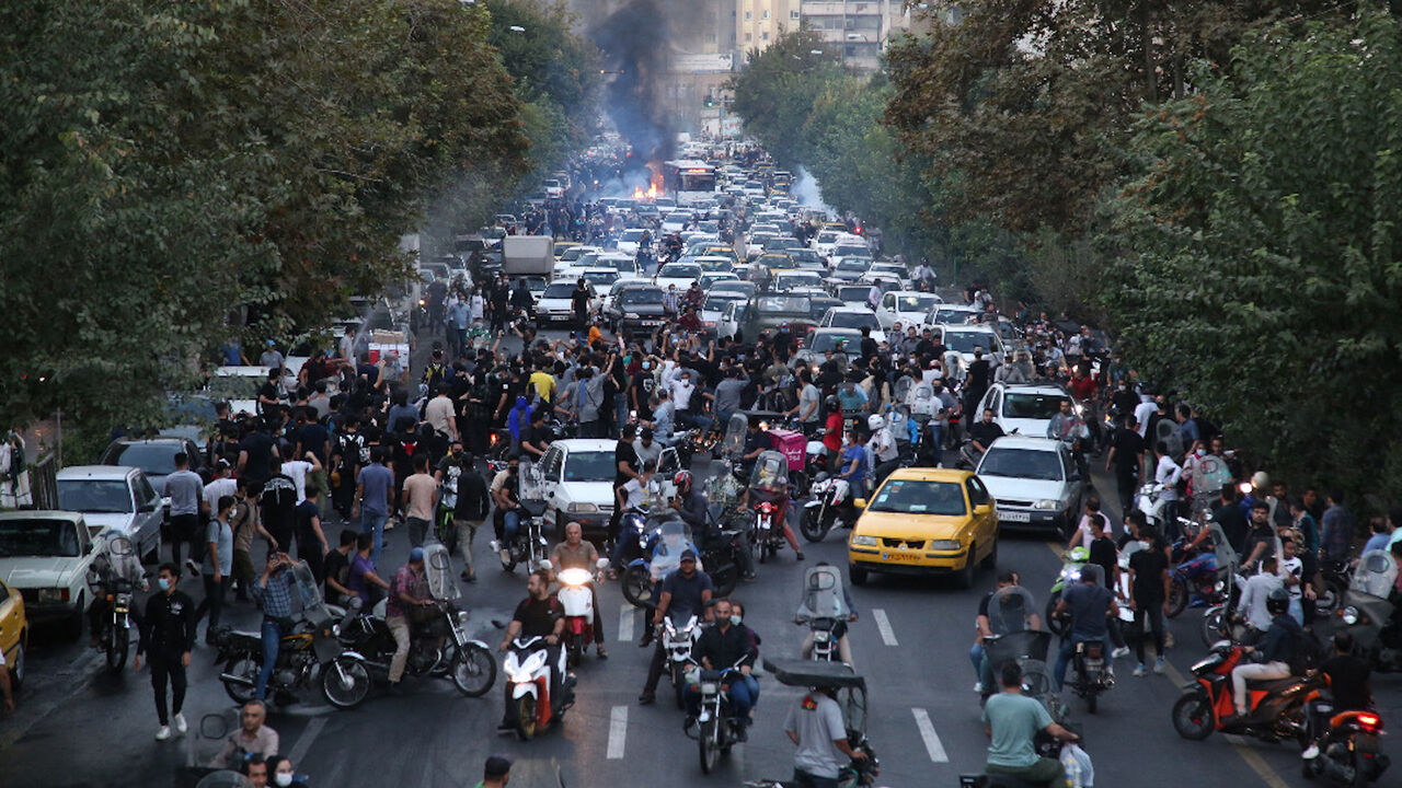 A picture obtained by AFP outside Iran on September 21, 2022, shows Iranian demonstrators taking to the streets of the capital Tehran during a protest for Mahsa Amini, days after she died in police custody.