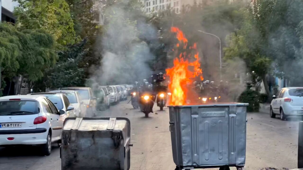 A picture obtained by AFP outside Iran shows a bin burning during a protest in Tehran on September 20, 2022 A picture obtained by AFP outside Iran shows a bin burning during a protest in Tehran on September 20, 2022