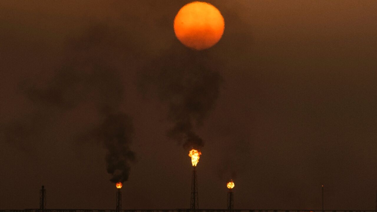 Flare stacks burn off excess gas in southern Iraq, at the Zubair oil and gas field north of Basra, on July 13, 2022