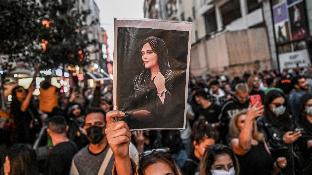 A protester in Istanbul holds aloft a photograph of Mahsa (Jhina) Amini, the young Kurdish woman who died in the custody of Iran's morality police who arrested her for an alleged infraction of the country's mandatory dress code for women A protester in Istanbul holds aloft a photograph of Mahsa (Jhina) Amini, the young Kurdish woman who died in the custody of Iran's morality police who arrested her for an alleged infraction of the country's mandatory dress code for women