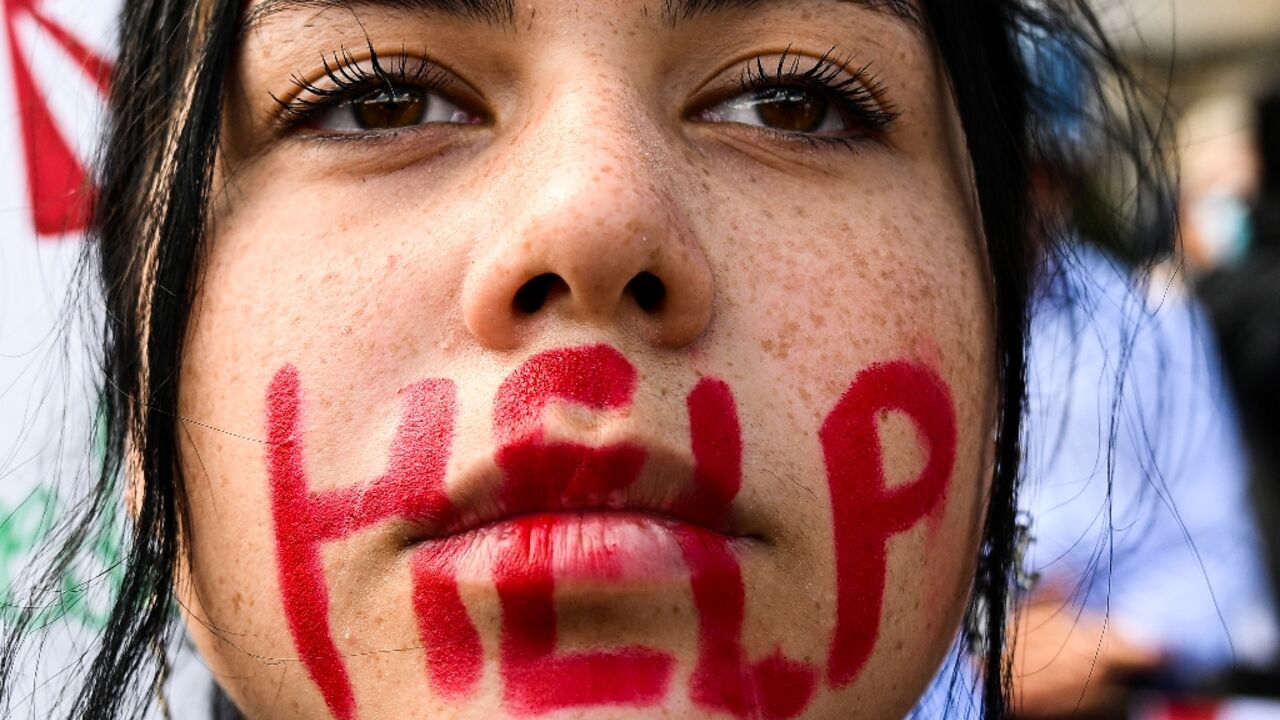 A young woman takes part in a protest on October 1, 2022 in Rome, following the death last month of Kurdish woman Mahsa Amini in Iranian morality police custody