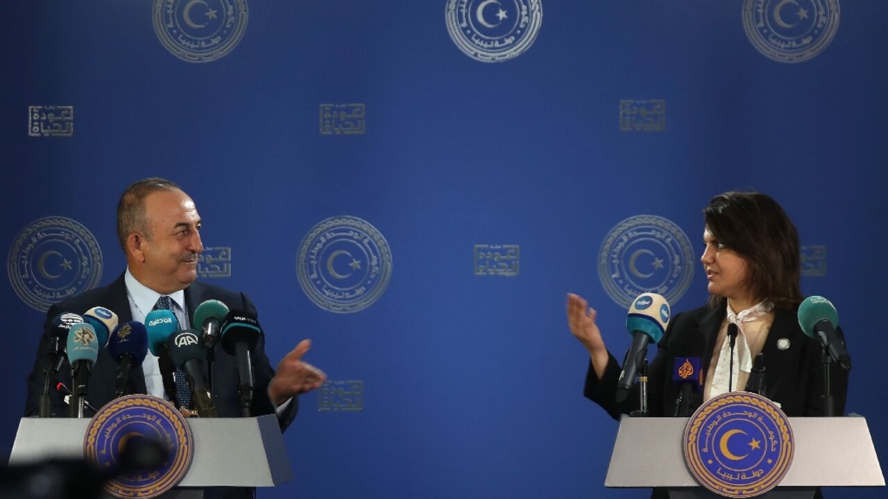 Libyan Foreign Minister Najla al-Mangoush and Turkish Foreign Minister Mevlut Cavusoglu speak to reporters after s signing a maritime gas deal