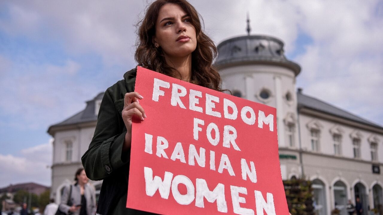 A woman takes part in a rally in support of Iranian women in Pristina on October 12, 2022 A woman takes part in a rally in support of Iranian women in Pristina on October 12, 2022