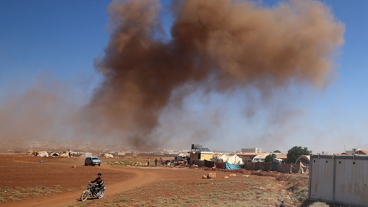 Smoke billows following Russian airstrikes near Syria's Bab al-Hawa border crossing with Turkey, Sept. 27, 2022.