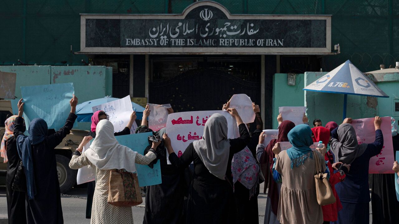 Afghan women hold placards as they take part in a protest in front of the Iranian Embassy in Kabul on Sept. 29, 2022.