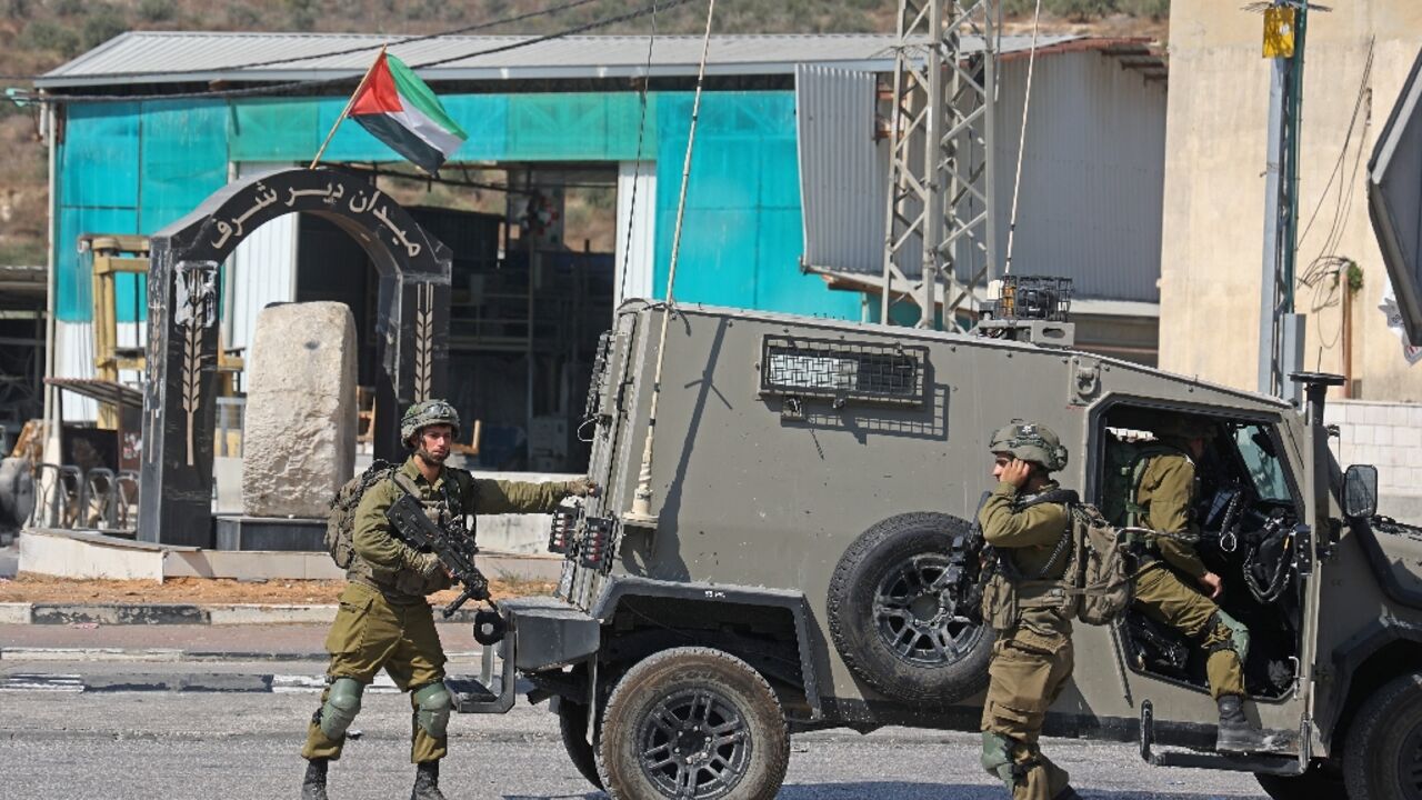 Israeli security forces deploy in the Deir Sharaf area, near the Israeli settlement of Shavei Shomron, west of Nablus in the occupied West Bank, on October 11 Israeli security forces deploy in the Deir Sharaf area, near the Israeli settlement of Shavei Shomron, west of Nablus in the occupied West Bank, on October 11