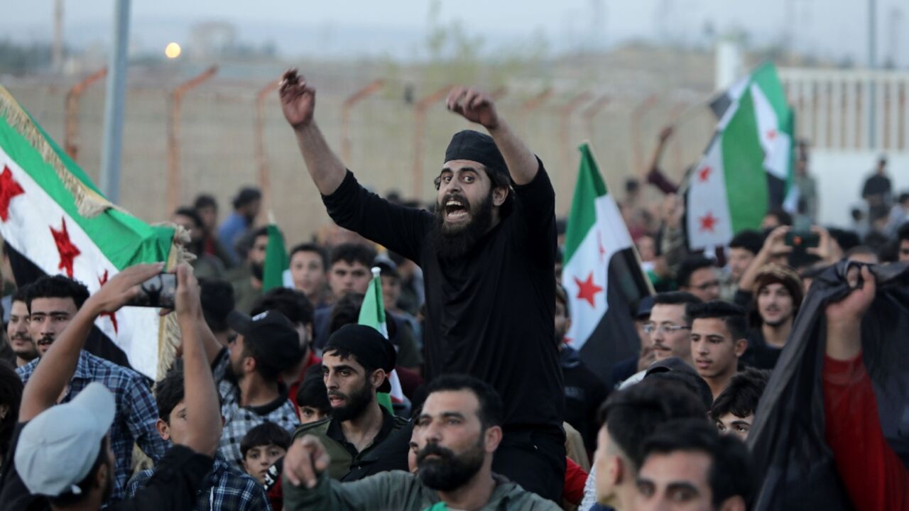 Demonstrators gather in the Syrian opposition-held border post with Turkey in Aleppo province on October 17, as civilians flee the advance of the the Hayat Tahrir al-Sham (HTS) jihadist group Demonstrators gather in the Syrian opposition-held border post with Turkey in Aleppo province on October 17, as civilians flee the advance of the the Hayat Tahrir al-Sham (HTS) jihadist group