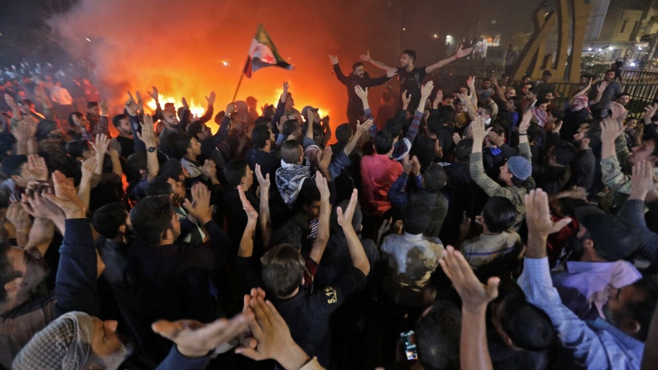 Crowds chant slogans in the Syrian opposition-held town of al-Bab, near the border with Turkey on October 16, in demonstrations against the Hayat Tahrir al-Sham (HTS) jihadist group Crowds chant slogans in the Syrian opposition-held town of al-Bab, near the border with Turkey on October 16, in demonstrations against the Hayat Tahrir al-Sham (HTS) jihadist group