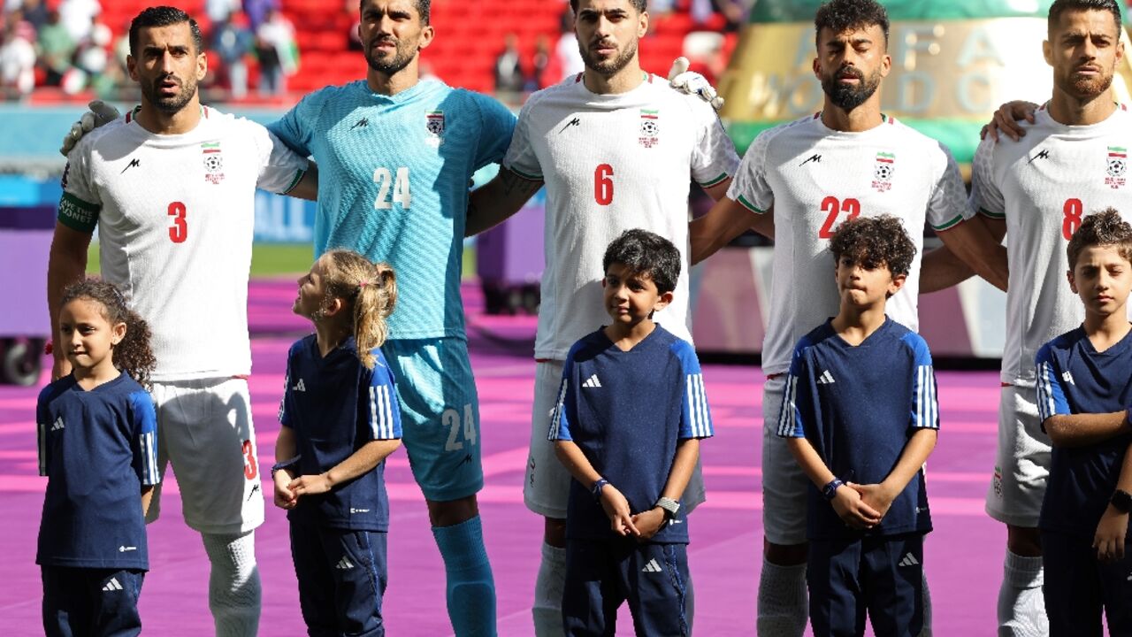 Iran's players sing their national anthem prior to the game against Wales