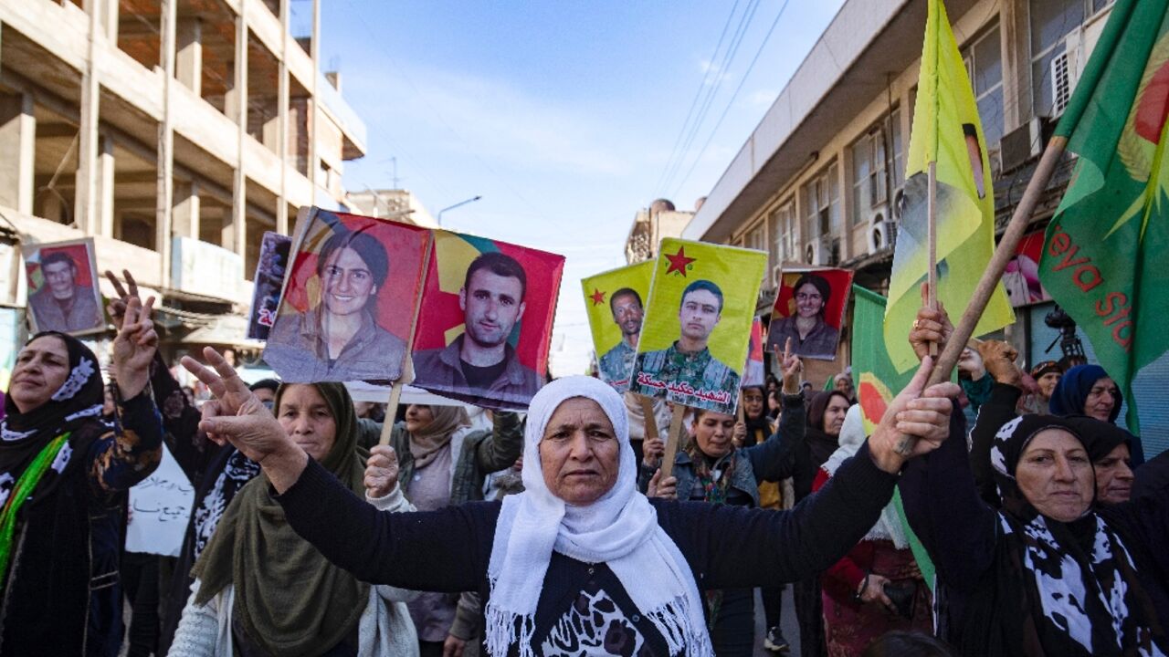 Syrian-Kurdish demonstrators in Qamishli raise pictures of people killed in Turkish strikes Syrian-Kurdish demonstrators in Qamishli raise pictures of people killed in Turkish strikes