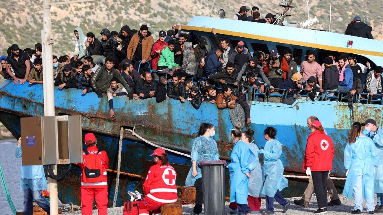 Hellenic Red Cross rescuers and health workers readied to help passengers disembark Hellenic Red Cross rescuers and health workers readied to help passengers disembark